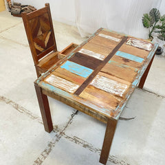 a wooden bench sitting in the middle of a sidewalk  a wooden bench sitting in the middle of a sidewalk