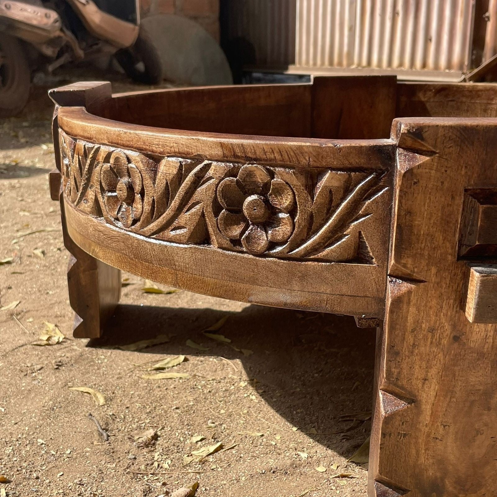 a wooden bench sitting in a dirt field  a wooden bench sitting in a dirt field