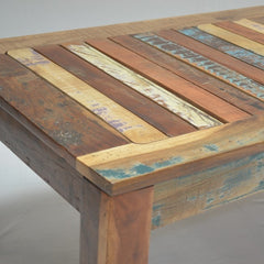 a wooden bench sitting in the middle of a street  a wooden bench sitting in the middle of a street