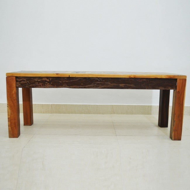 a wooden bench sitting in the middle of a room 