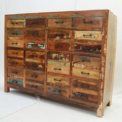 a wooden dresser with a bunch of books on it 