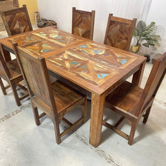 a wooden table and chairs in a room 