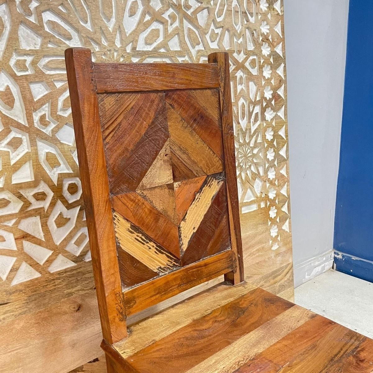 a wooden chair sitting in front of a window 