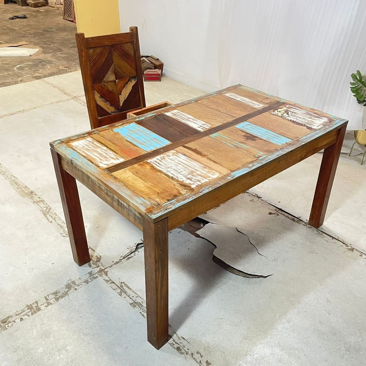 a wooden chair sitting in front of a wooden bench 