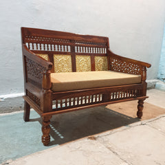 Curved wooden armrest with decorative cut-out detailing