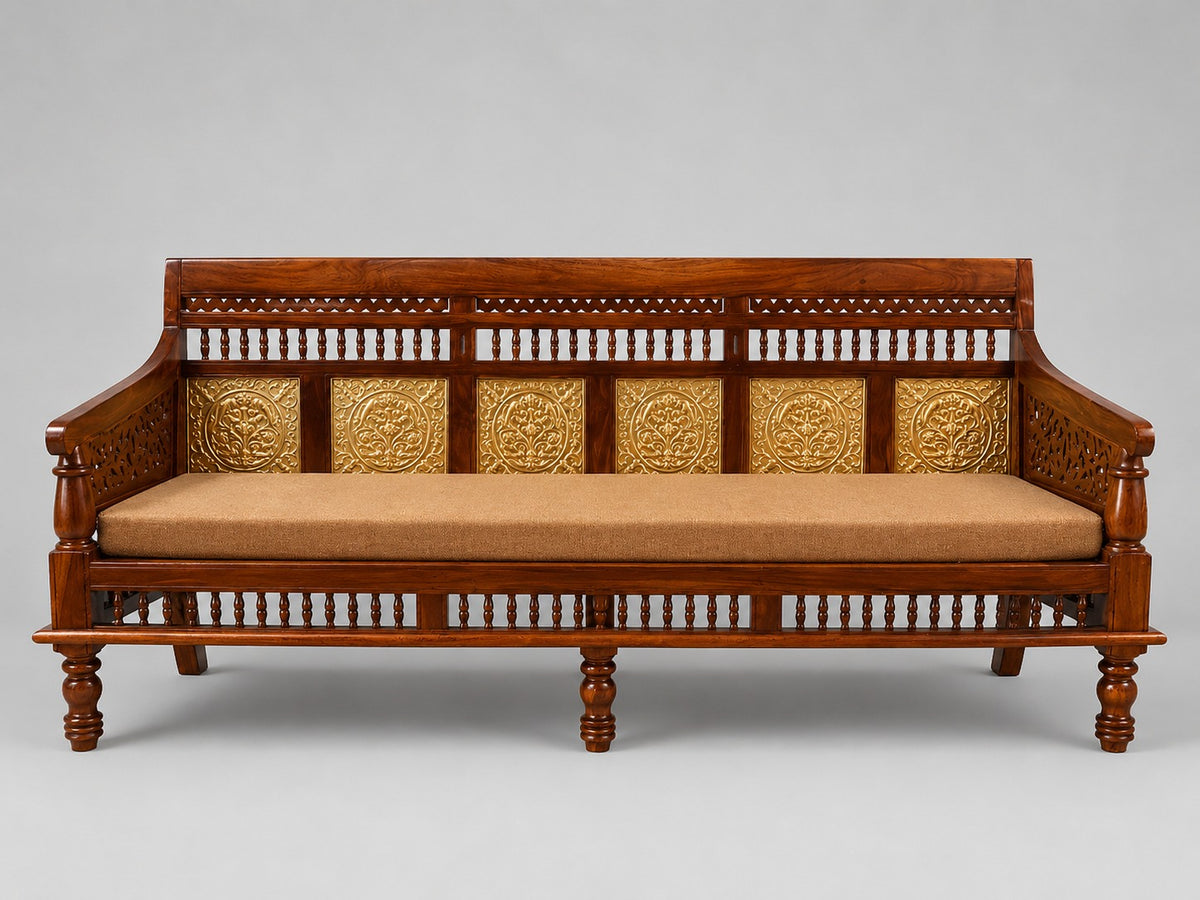 Traditional Indian wooden daybed with ornate brass floral panels