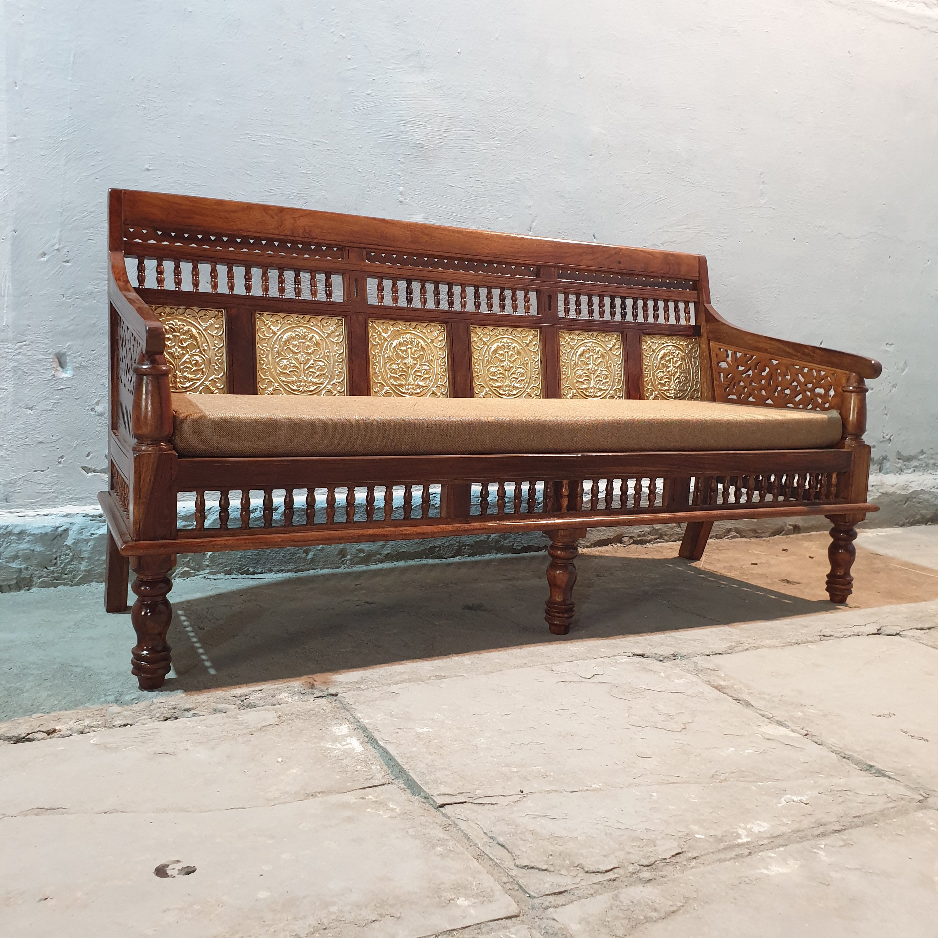 Curved wooden armrest with intricate cut-out detailing